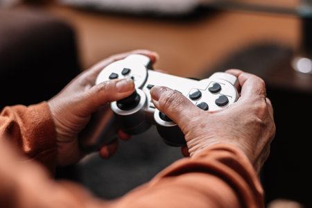 Unrecognizable woman playing video game console. Mature Caucasian woman playing video game console.