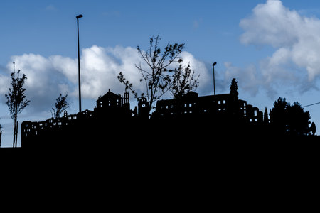 black silhouette of a small village with blue cloudy sky