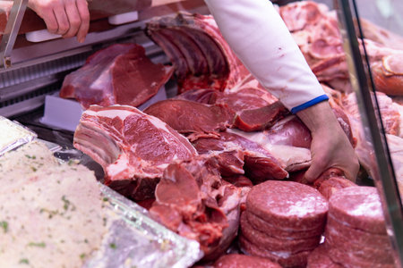 Close up man's hands working on butcher's shopの写真素材