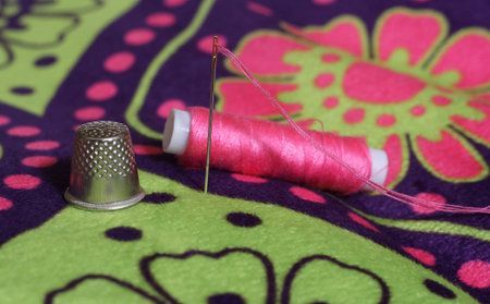 Thimble and Pink Thread on Vintage Floral Fabric
