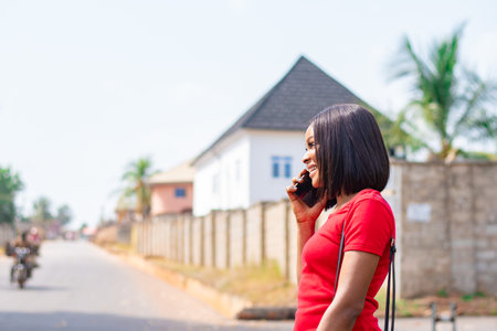 pretty african lady making a phone call smilingの写真素材