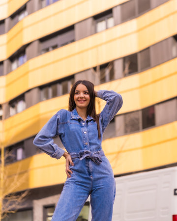Young caucasian girl with a monkey cowboy in a yellow and black house. Enjoying the city on vacation, a young girl lifestyle, in a trendy posing smilingの写真素材
