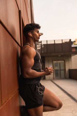 Arab young man doing sport exercises in the city, pose of the strong young manの写真素材