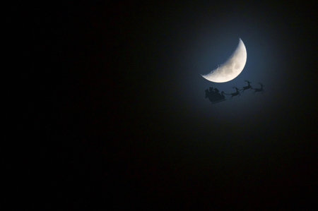 Santa's Sleigh And Reindeer's  In Front of  Moon On A Clear Blue Sky