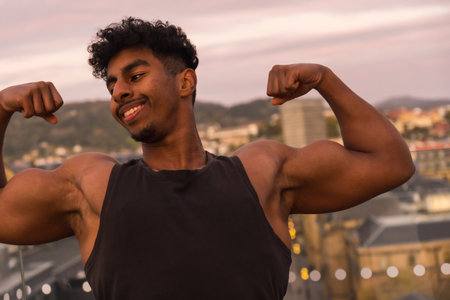 Arab young bodybuilder doing sports in the city, showing off his big arm muscleの写真素材