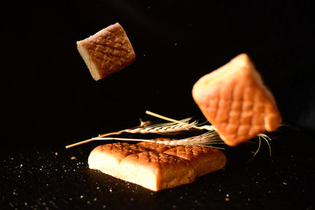 bread background with wheat isolated on black.の写真素材