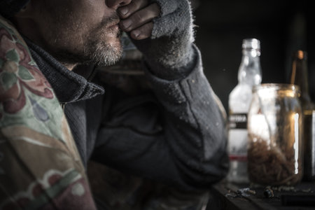 Homeless Alcoholic Caucasian Male in His 40s Close Up. Alcoholism Problem Conceptual Photoの写真素材