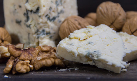 roquefort cheese with walnuts on dark backgroundの写真素材