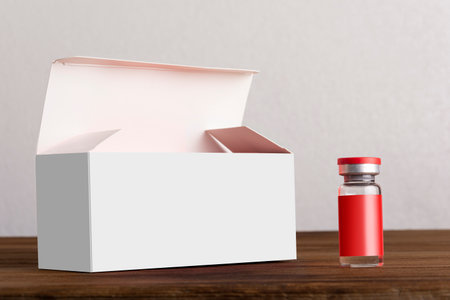 Opened vials box with a vial at front on wooden board. editable mock-up series template ready for your design. label and box faces selection path included.の写真素材