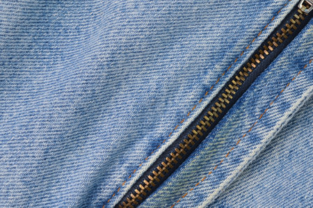 Denim blue jeans texture background with closed zipper