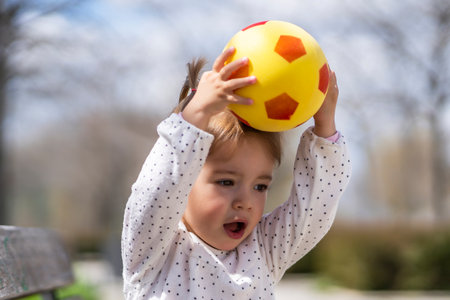 girl playing with her ball in the parkの写真素材