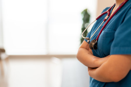 unrecognizable doctor wearing surgery clothes and arm crossed with empty copy space.の写真素材