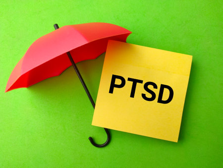 Red umbrella and sticky note with the word PTSD.の写真素材