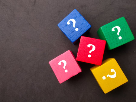 Top view colored wooden cubes with question icons. The concept of question marksの写真素材