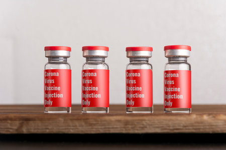 Rows of medical vials for injection isolated on gray background. Medicine and healthcare concept....