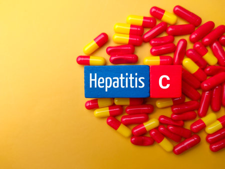 Top view medical pill and colored cube with the word Hepatitis C. Medical concept.の写真素材