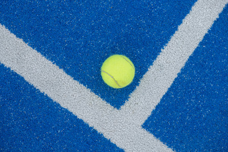 Tennis ball on a blue paddle tennis court, racket sports conceptの写真素材
