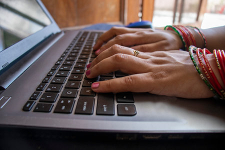 Female wearing bangles and working form home.の写真素材