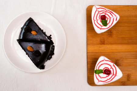 Stock Photo - Homemade bakery: chocolate fudge cake decorated with chocolate curl. Triangle slice piece of chocolate cake on rustic wood table for cafe,meeting, coffee break or tea time and birthday partyの写真素材