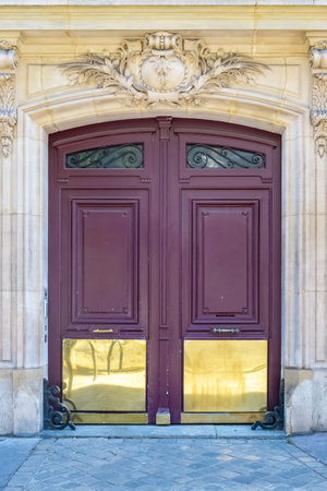 Paris, an old wooden door, typical building in the centerの写真素材