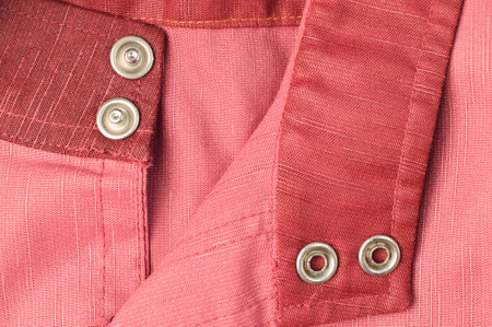 Close up view of silver buttons on cloth