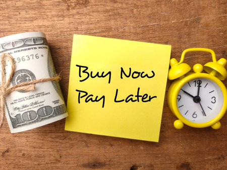Banknotes,clock and sticky note with the word Buy Now Pay Later.の写真素材