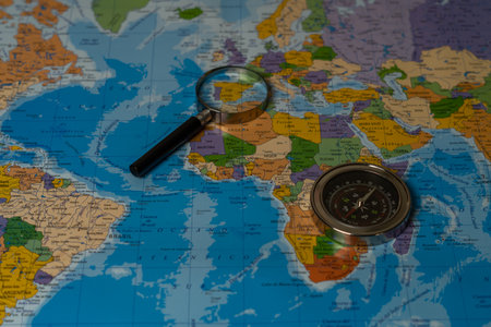 zenithal view world map with compass and magnifying glassの写真素材