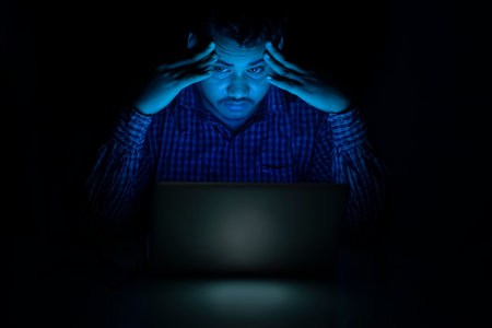 corporate employee feeling tired and headache while working late night on laptop
