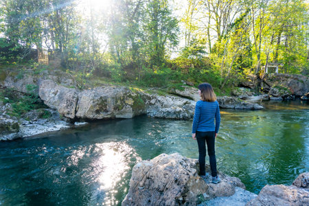 A young tourist enjoying the Sella river near the town of Cangas de Onis. Asturias. Spainの写真素材
