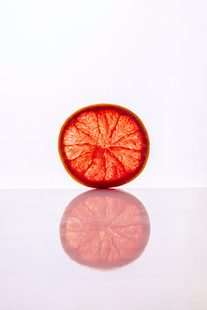 Slice of grapefruit cutaway isolated on white background. Close-upの写真素材