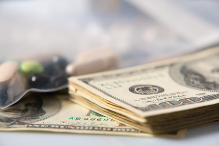 Dollar Bills and Pills. Drugs in plastic bag with cash money. Illegal Drugs in package. 100 Dollar billsの写真素材