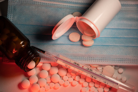 Blue Clinical mask with glass mercury rising Thermometer. Diagnostic and protection for Coronavirus and Fluの写真素材