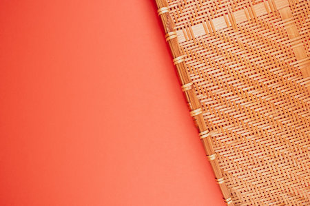 A top view of bamboo wicker tray isolated on red backgroundの写真素材