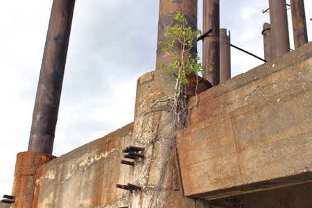 Static steel-concrete beam with rusty screws at an abandoned or lost place
