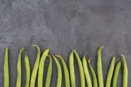 Green string beans on a  textured background, empty copy space for text, fresh vegetablesの写真素材