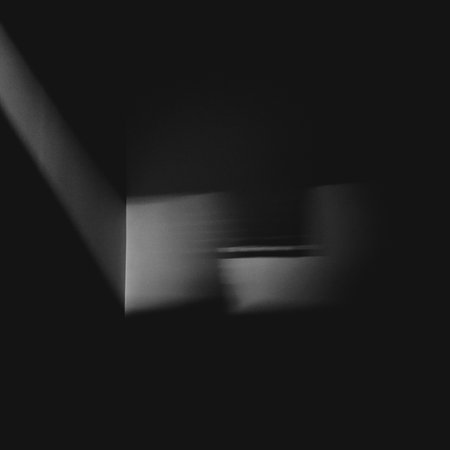A greyscale shot of blurred lights on a dark backgroundの写真素材