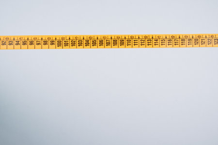 A closeup shot of a yellow measuring on white backgroundの写真素材