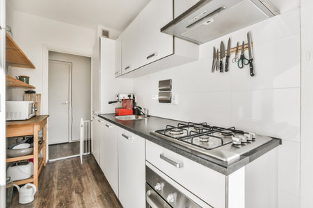 A kitchen with the furniture in it and the bright light coming from the window