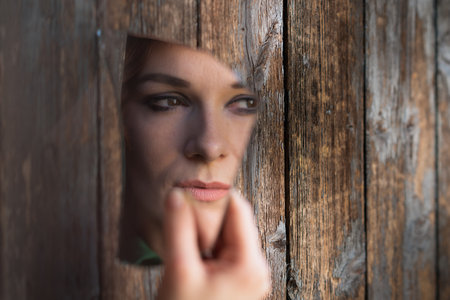 A shallow focus shot of an elegant European woman from Germany holding a broken piece of mirrorの写真素材