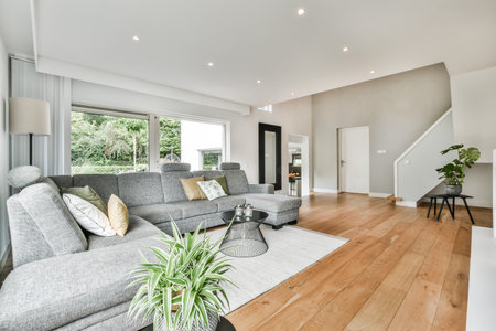A modern room with different furniture and the bright light coming from the window