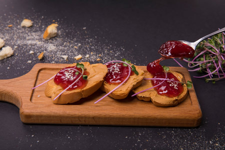 A closeup shot of lingonberry jam sandwiches on a wooden board
