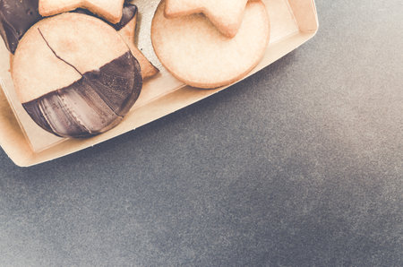 A top view of chocolate cookies on a box in a concrete surface