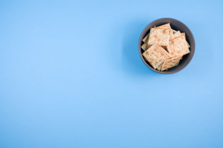 A top view shot of bread chips on a blue backgroundの写真素材