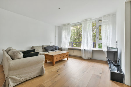 A modern room with furniture and the bright light coming from the window