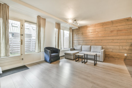 A kitchen with the furniture in it and the bright light coming from the windowの写真素材