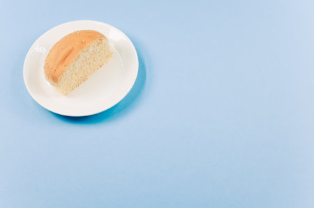 A closeup shot of half bread on a blue background