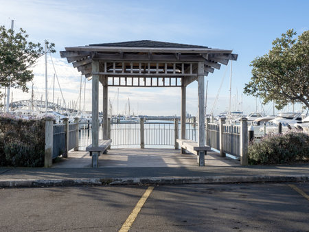 a white gazebo at seashore with port with wboatsの写真素材