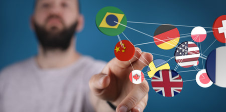 A businessman selecting from an interconnected network of international flagsの写真素材