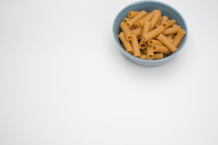A top view of rigatoni pasta on a bowl isolated on white backgroundの写真素材