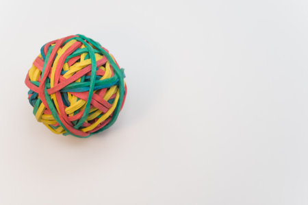 A closeup shot of a colorful rubber band ball isolated on white background